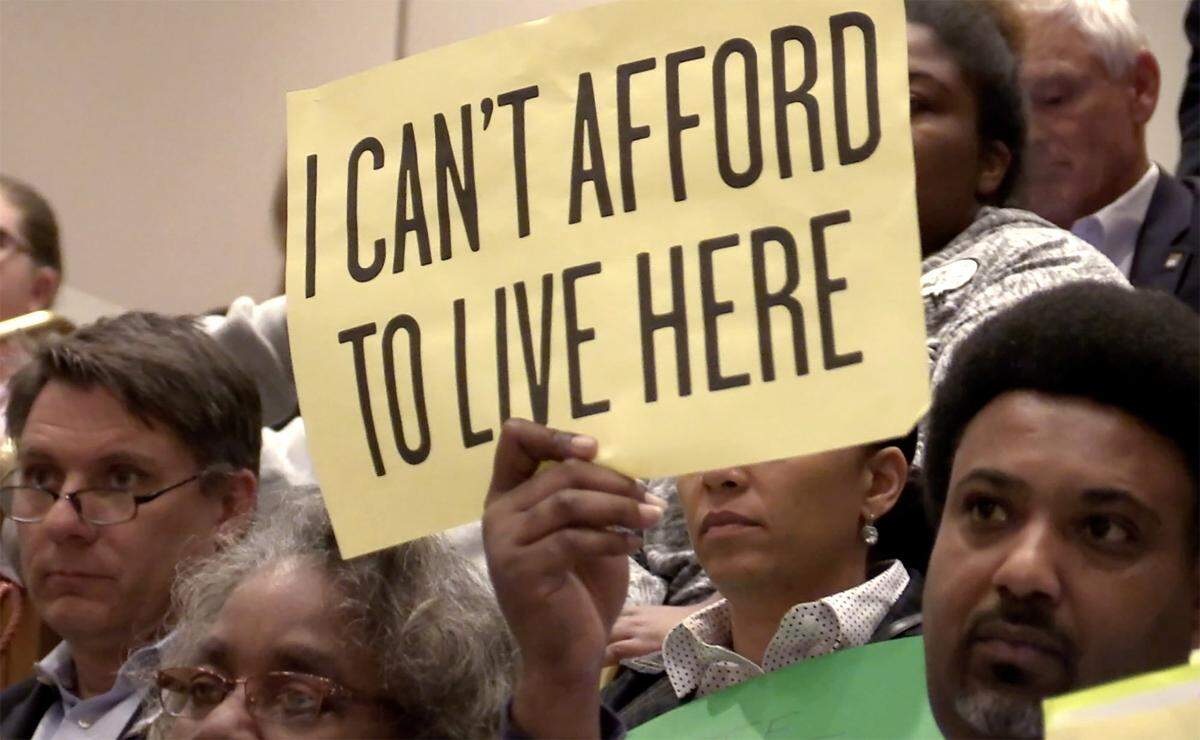Citizens arrived at the Charlotte City Counsel meeting on Monday, April 9, 2018 with signs referencing affordable housing. More than a third of households in Charlotte are “cost-burdened,” which means they spend more than 30% of their income on housing, according to a city report. The federal government says that leaves them with too little money for food, clothes, medicine and other basic needs.