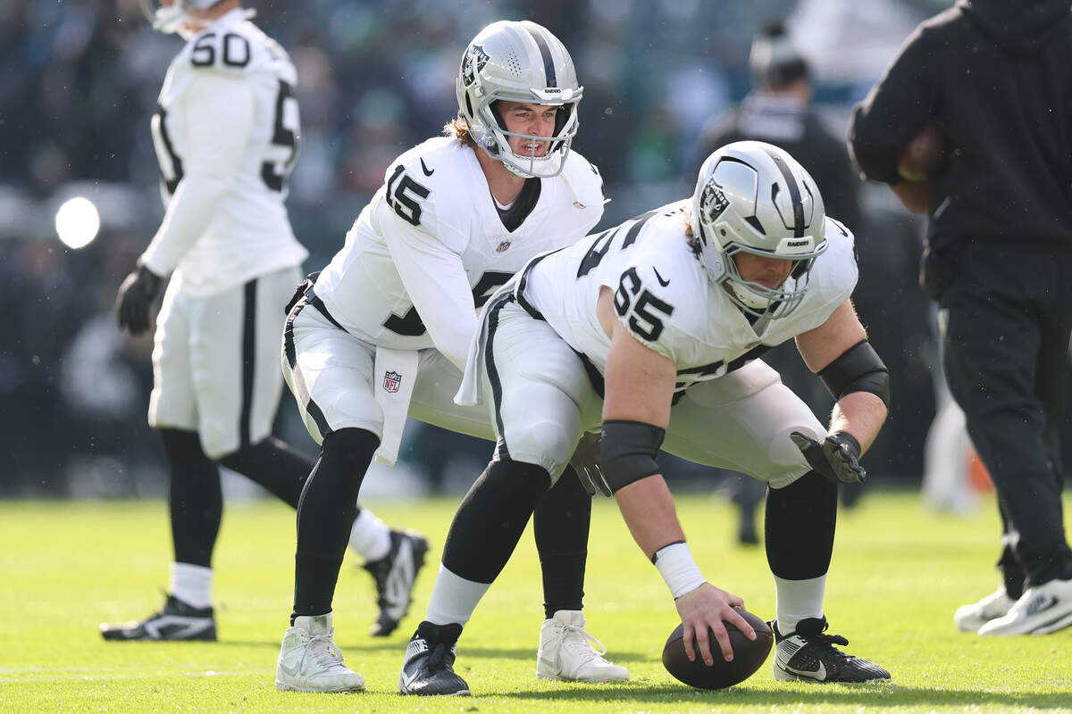 Then-Las Vegas Raiders QB Kenny Pickett, left, and center/guard Alex Cappa warm up before the game against the Philadelphia Eagles at Lincoln Financial Field on Dec. 14, 2025 in Philadelphia, Pennsylvania.