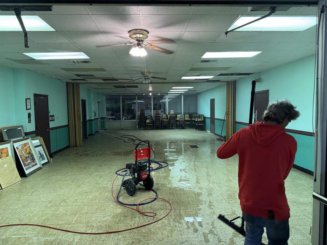 A person cleans floors in a Fayetteville hotel where Cedric Dean says he paid thousands of dollars to renovate the property.