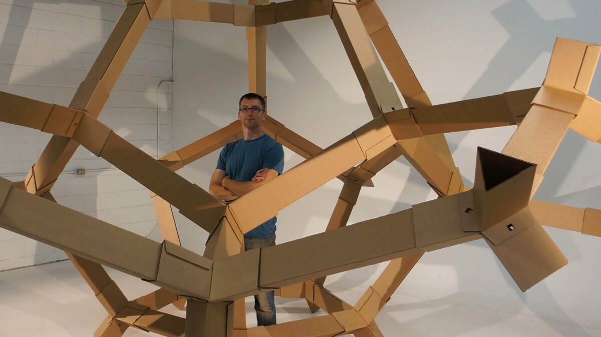 Richard Elaver, an artist and ASU design professor, stands inside one of his 3D works. This Do-dec sculpture is a work in progress. Elaver integrates the tools of industrial design with the craft of metalsmithing.