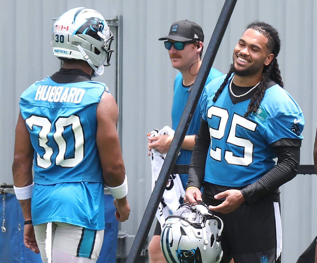 Carolina Panthers running backs Chuba Hubbard, left and Jonathon Brooks, right, talk during a break in the team's first open workout on Tuesday, May 26, 2026.