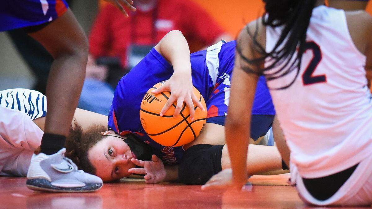 North Mecklenburg’s Jaden Redfern (22) recovers a ;loose ball past Chambers’ Aaliyah El (2) during a game at Chambers High School in Charlotte, N.C., Friday, Feb. 4, 2022. North Mecklenburg beat Chambers 52-46.