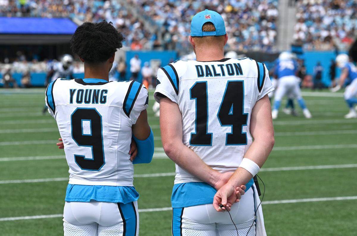Carolina Panthers quarterbacks Bryce Young, left and Andy Dalton while watching the team’s loss to the Los Angeles Chargers on Sept. 15.