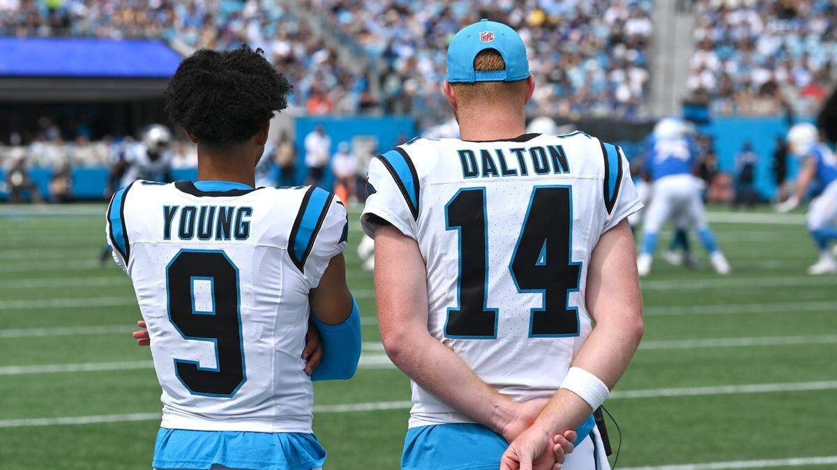 Carolina Panthers quarterbacks Bryce Young (9) and Andy Dalton (14) watch the defense Sunday in Carolina’s 26-3 loss to the Los Angeles Chargers. On Monday, coach Dave Canales announced that Young will be replaced as the starting QB by Dalton.