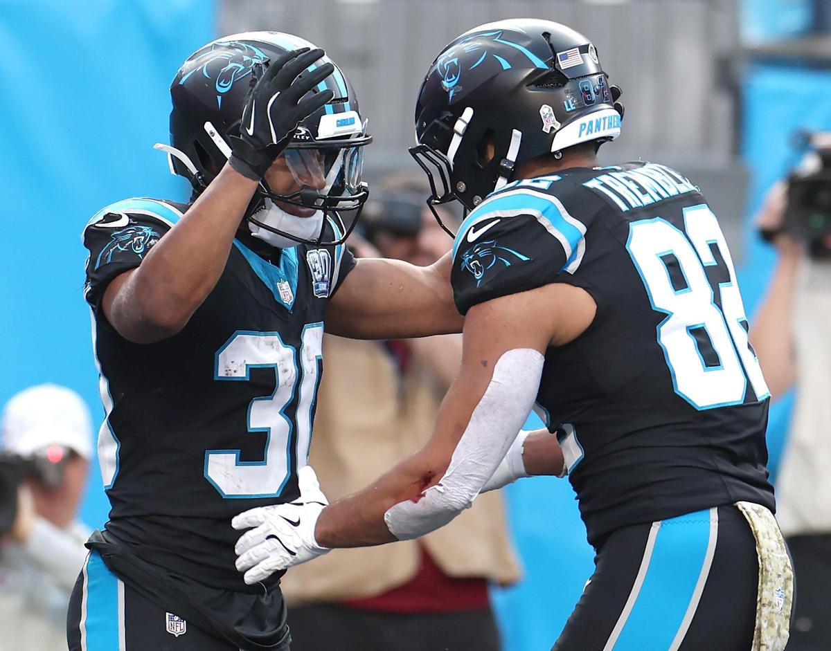 Carolina Panthers running back Chuba Hubbard, left, is congratulated by tight end Tommy Tremble, right, after Hubbard scored a touchdown during action against the Kansas City Chiefs at Bank of America Stadium in Charlotte, NC on Sunday, November 24, 2024. The Chiefs defeated the Panthers 30-27.