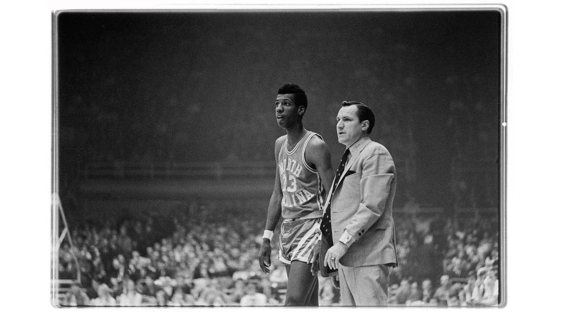 UNC coach Dean Smith (right) is pictured with Charlie Scott during the 1969 ACC Tournament in Charlotte in this (Raleigh) News & Observer file photo.