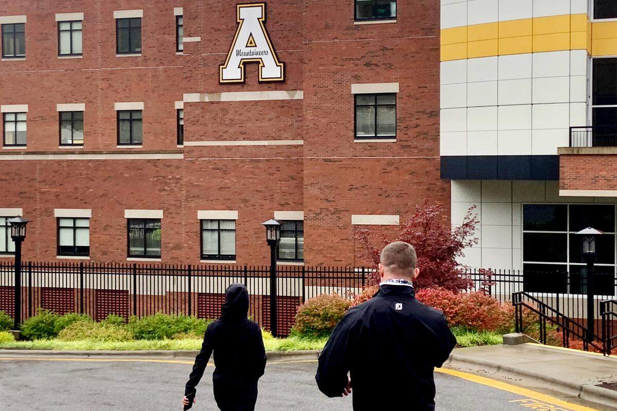 Dan and Beth Reynolds look for a location outside Kidd Brewer Stadium at Appalachian State to try to watch their son, Charlotte 49ers quarterback Chris Reynolds, play in a football game Saturday. They weren’t allowed to attend due to COVID-19 regulations.
