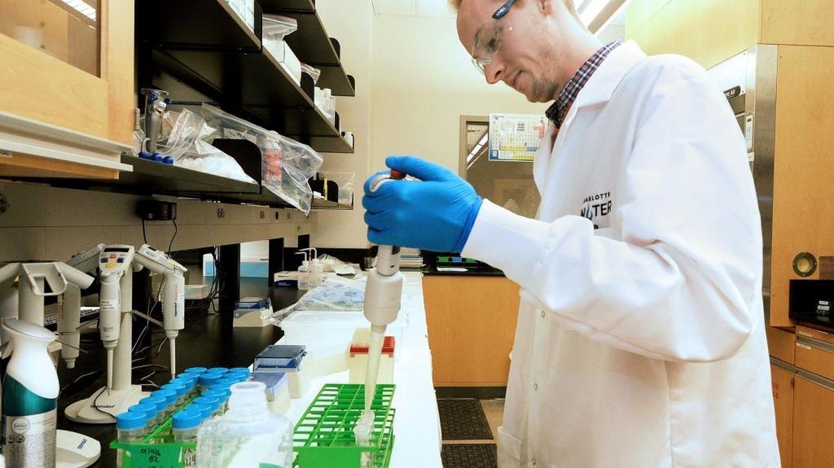 A lab technician tests water in the lab at Charlotte Water's Environmental Services Facility.