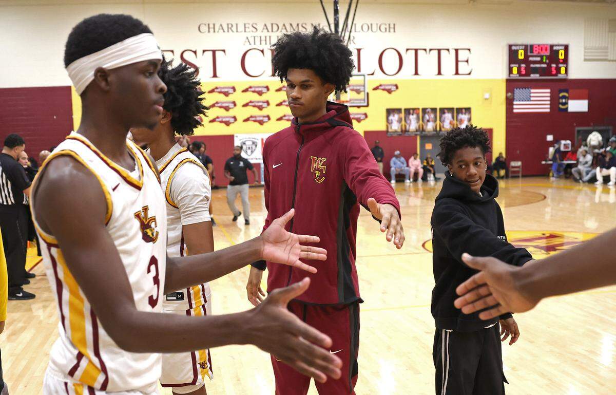 Janon Singh, center, welcomes West Charlotte Lions basketball team starters to the floor during introductions on Saturday, January 17, 2026. Singh, a junior is a top national recruit. West Charlotte hosted Hillside in a battle of traditionally black schools in the MLK Peace Basketball Showcase at West Charlotte High School in Charlotte, NC.
