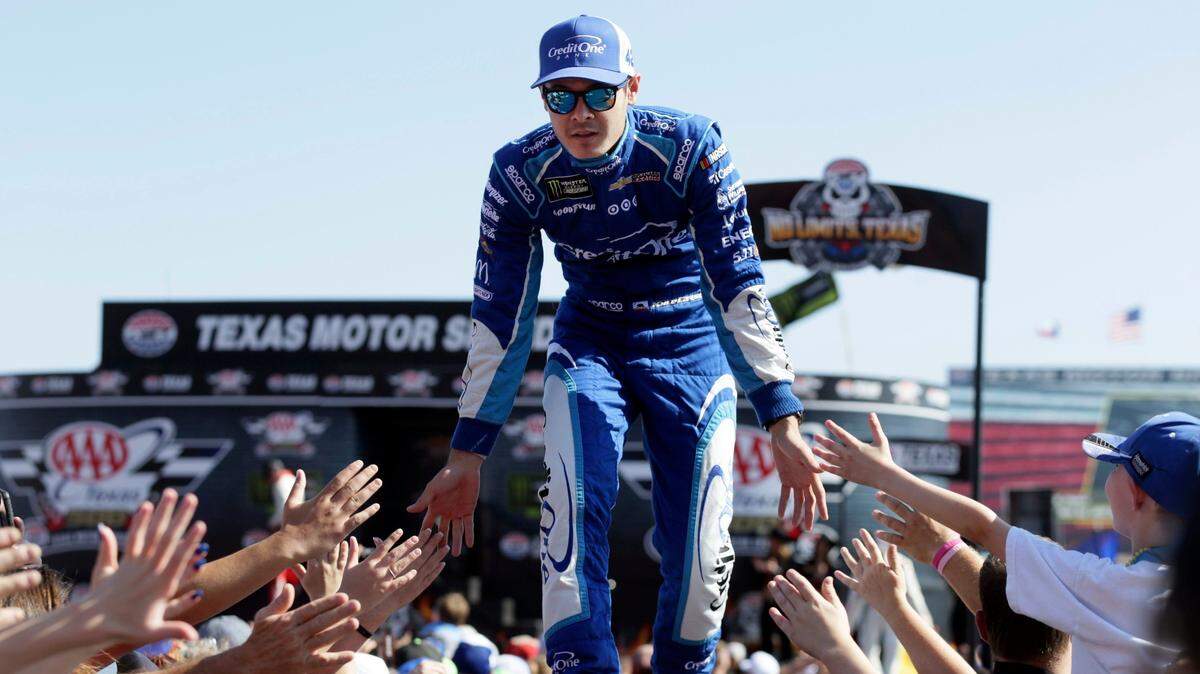 FILE - In this Nov. 5, 2017, file photo, Kyle Larson greets fans during driver introductions before the NASCAR Cup Series auto race at Texas Motor Speedway in Fort Worth, Texas. As Larsen enters his sixth season at NASCAR’s top level it is clear that once he starts winning on a consistent basis he could become the biggest star in the country. (AP Photo/LM Otero, File)