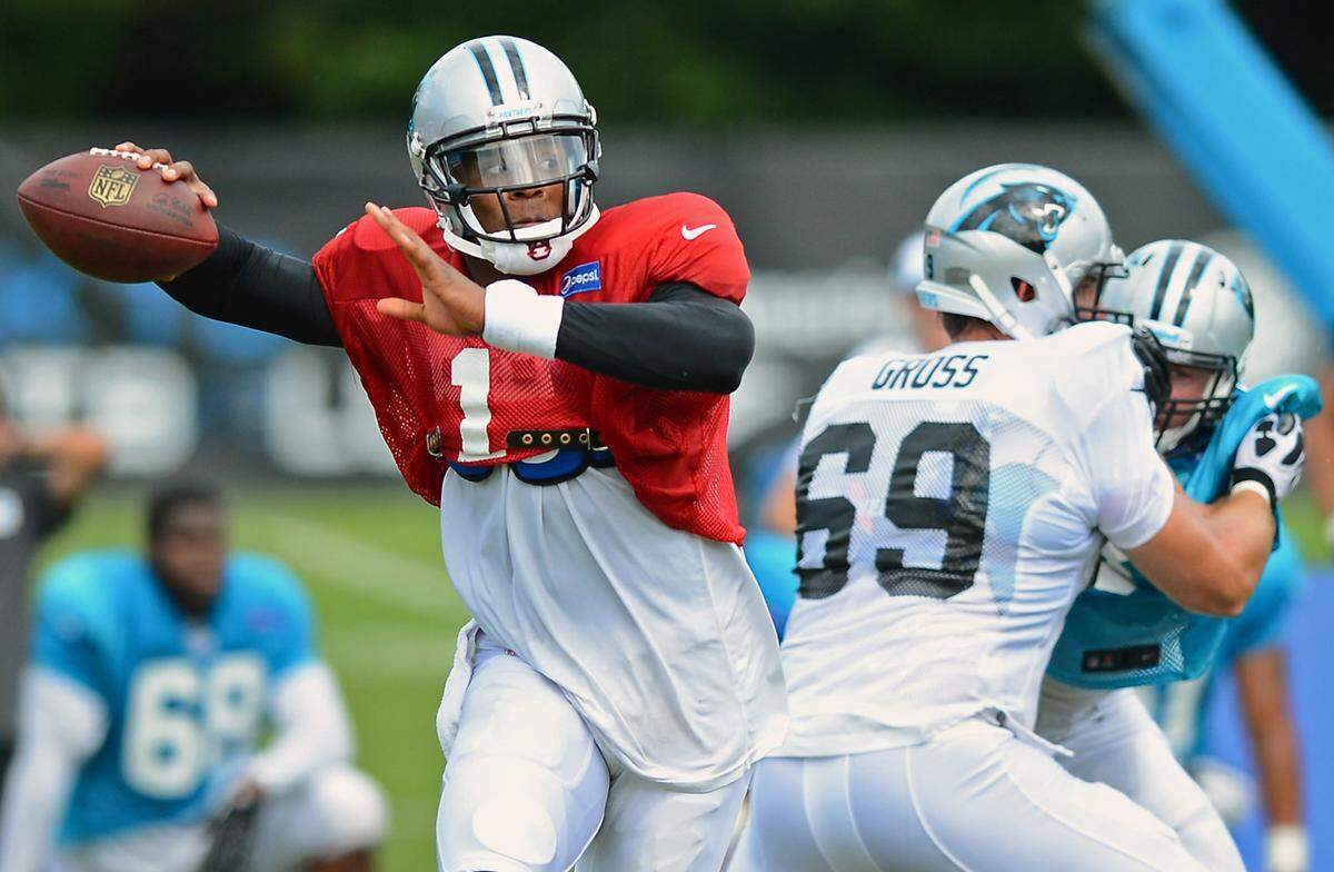 Carolina Panthers (1) quarterback Cam Newton breaks out of the pocket to pass as (69) tackle Jordan Gross provides protection during practice on Thursday, August 1, 2013 at Wofford College in Spartanburg, SC. Jeff Siner - jsiner@charlotteobserver.com