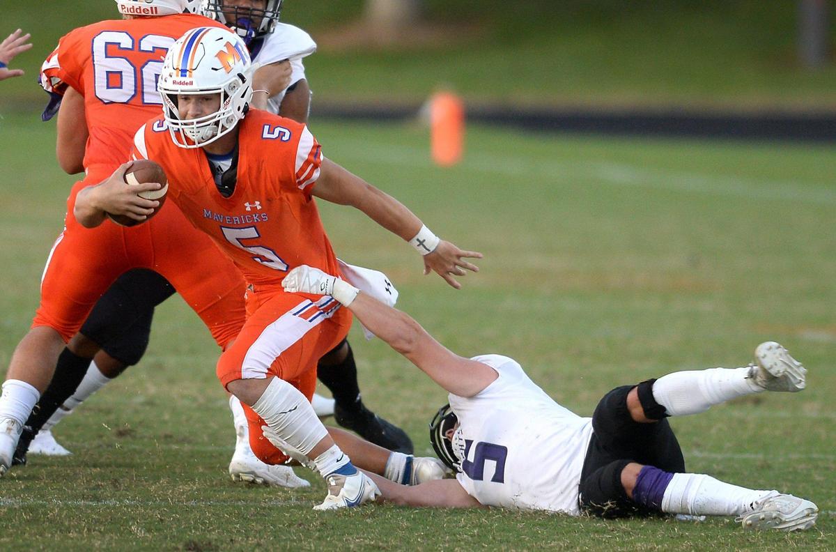 Ardrey Kell linebacker Blake Henninger, right, attempts to make a sack on Marvin Ridge quarterback Evan Medders, left, during first half action on Friday, September 3, 2021.
