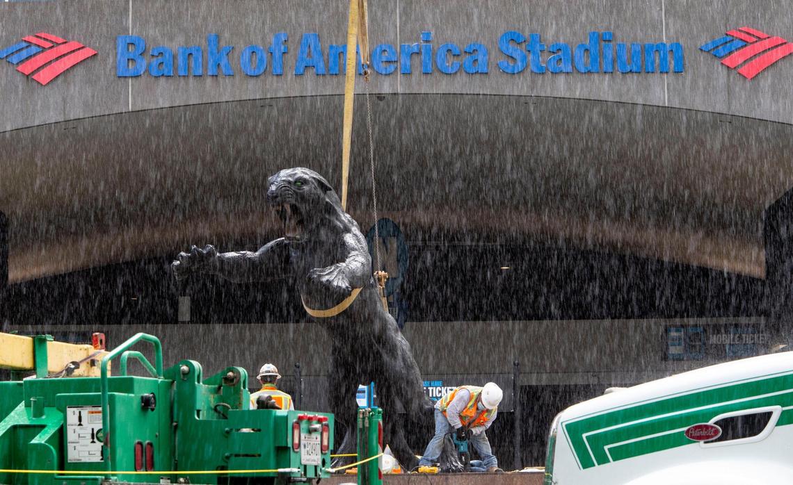Crews work through a short rain shower as they remove the three part statue of Jerry Richard flanked by two panthers in front of the Bank of America Stadium in Charlotte, NC on Wednesday, June 10, 2020. Richardson was the founder and majority owner of the Carolina Panthers team and sold his stake after an NFL investigation substantiated allegations of both sexual and racial misconduct.