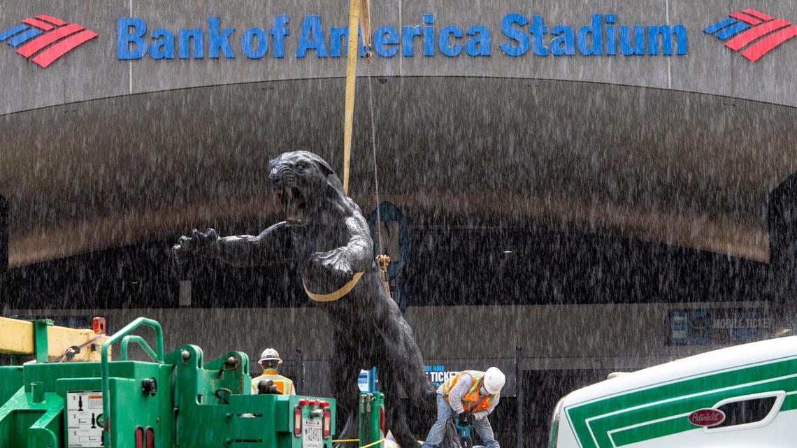 Crews work through a short rain shower as they remove the three part statue of Jerry Richard flanked by two panthers in front of the Bank of America Stadium in Charlotte, NC on Wednesday, June 10, 2020. Richardson was the founder and majority owner of the Carolina Panthers team and sold his stake after an NFL investigation substantiated allegations of both sexual and racial misconduct.