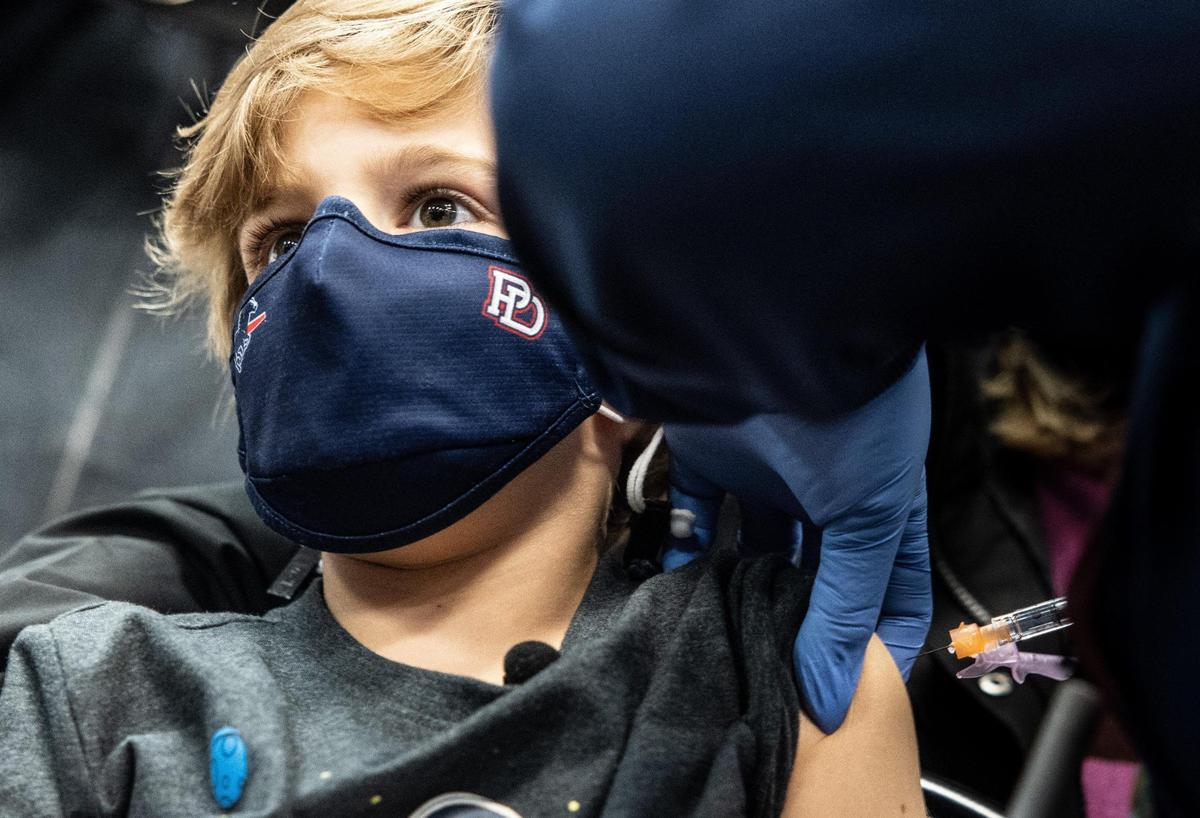 Teddy Rivers, 6, left gets a dose of the Covid-19 vaccine from Krystal Singleton at the Novant East Mecklenburg vaccine clinic in Charlotte, N.C., on Thursday, November 4, 2021.