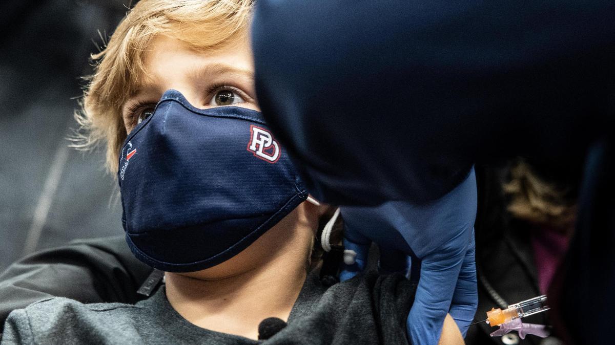 Teddy Rivers, 6, left gets a dose of the Covid-19 vaccine from Krystal Singleton at the Novant East Mecklenburg vaccine clinic in Charlotte, N.C., on Thursday, November 4, 2021.