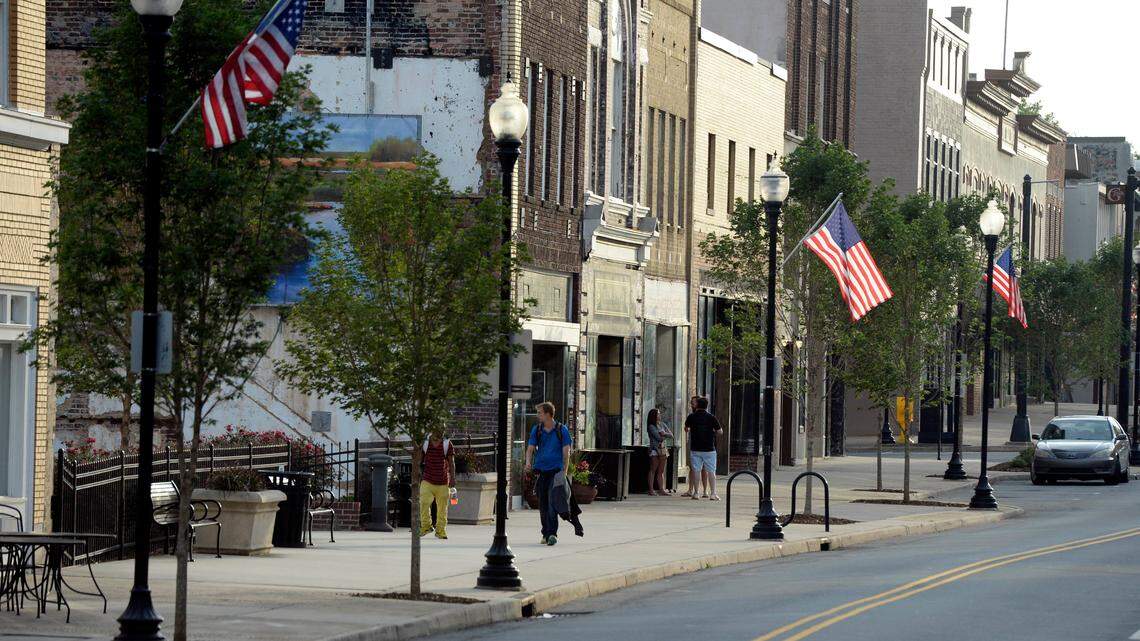 Pedestrians walk along Main Street in downtown Gastonia. Gaston County says it will allow businesses to reopen at 5 p.m. Wednesday, contradicting Gov. Roy Cooper’s statewide stay-at-home order that expires May 8.