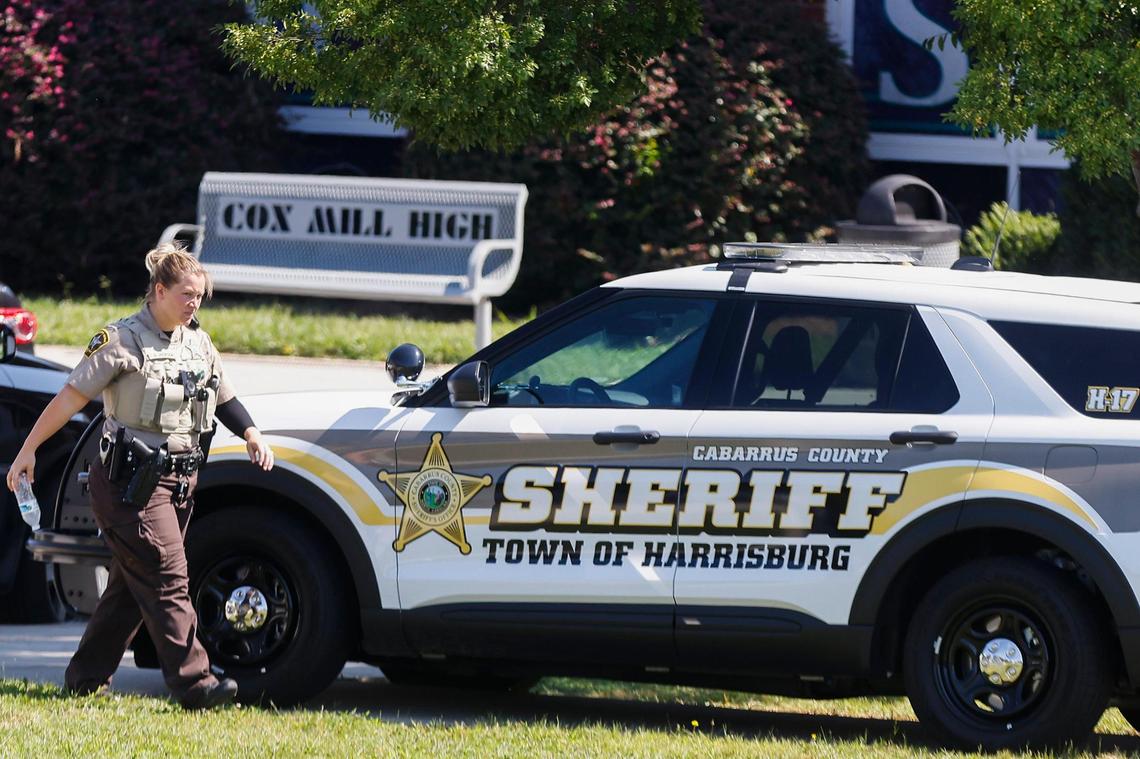 A Cabarrus County sheriff’s deputy walks to her vehicle following a bomb threat at Cox Mill High School in Concord, N.C., Tuesday, Sept. 20, 2022.