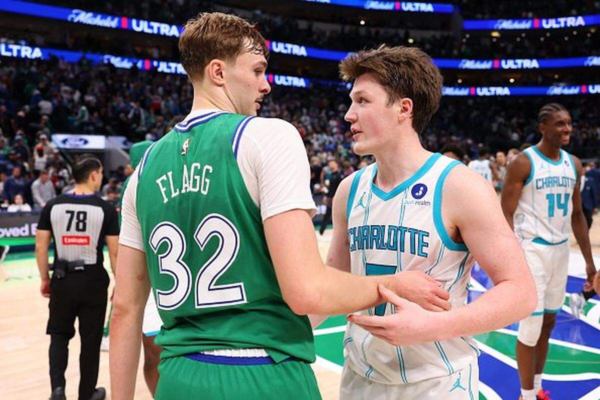 Cooper Flagg of the Dallas Mavericks and Kon Knueppel of the Charlotte Hornets talk after a game at American Airlines Center.