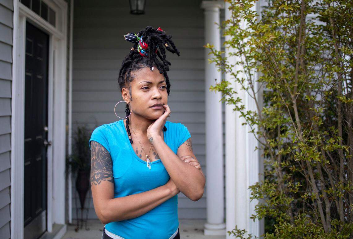 Crystal Howard stands outside the home she and her husband rent from Progress Residential on Cane Garden Drive in Raleigh. The company is one of a handful of about 20 firms that have bought up tens of thousands of homes across the state.