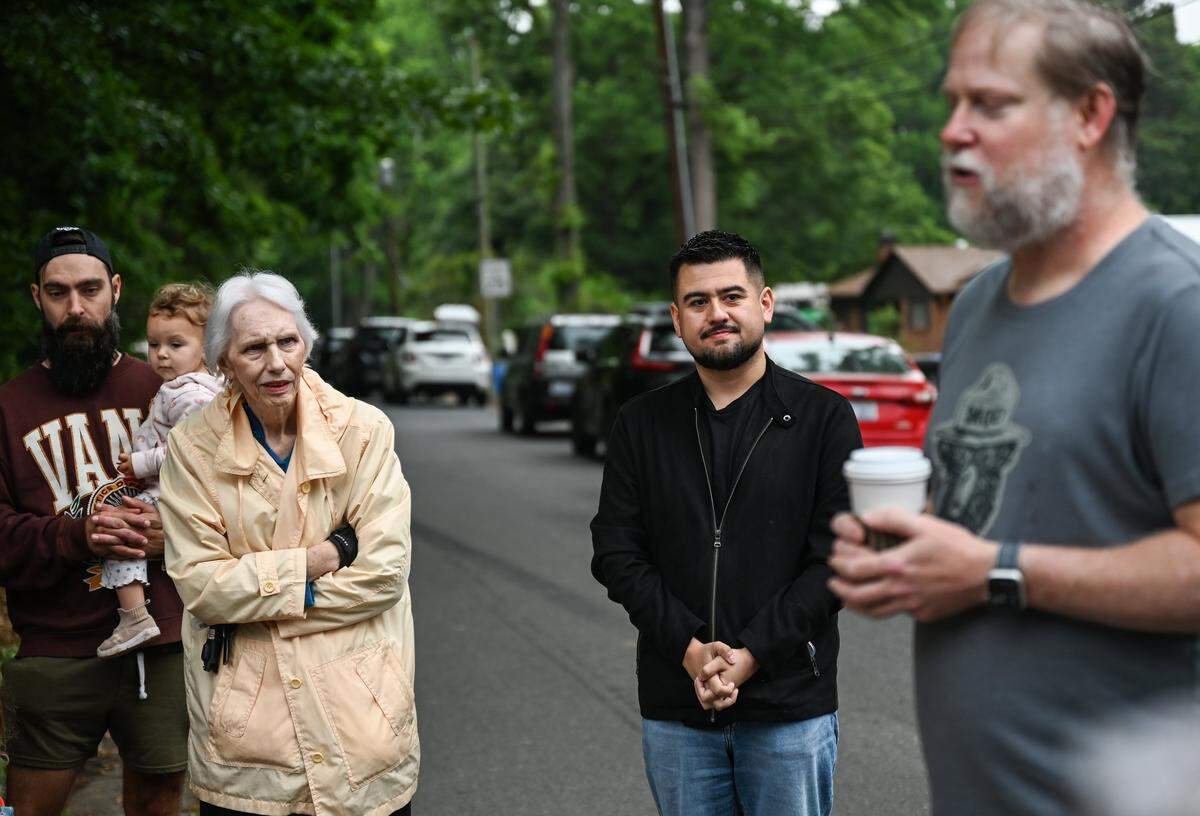 City Councilman, JD Mauera Azarias, representing district 5, joins east Charlotte residents as they hold a memorial service to mourn the loss of a 6.6 wooded acre area in their neighbirhood. The city approved a rezoning request that will replace the trees with new housing.