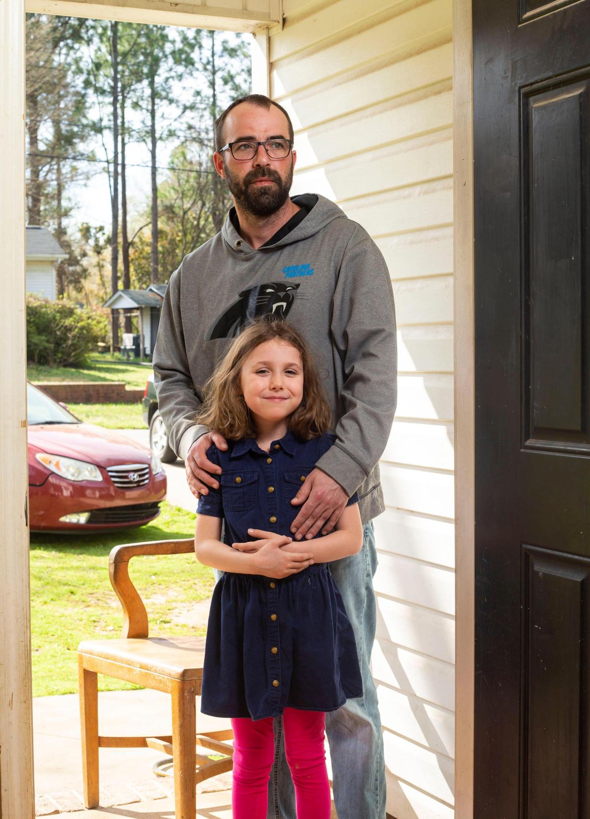 David Dockery and his daughter Zoey Dockery stand for a portrait at their home in Gastonia, NC on Friday, March 20, 2020. David was a bartender for Carolina Beer at the Charlotte Douglas International Airport and was abruptly laid-off Monday as operations were scaled back. “It’s not like I can go out and look for a job, the whole industry is turned off right now,” Dockery said adding he is scrambling to decide the next step.