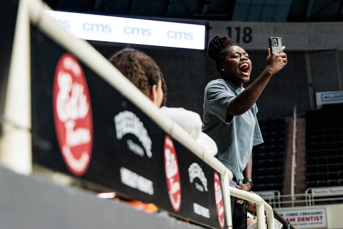 A Ballantyne Ride High School graduation guest cheers as students receive their diplomas.