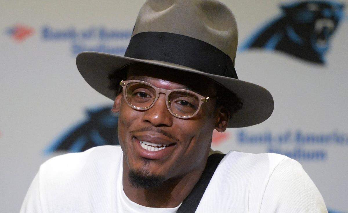 Carolina Panthers quarterback Cam Newton smiles as he  talks about the play that caused hims to briefly leave the game against the England Patriots at Bank of America Stadium on Friday, August 24, 2018. Newton suffered a black-eye and swelling along the eyebrow because of the play.