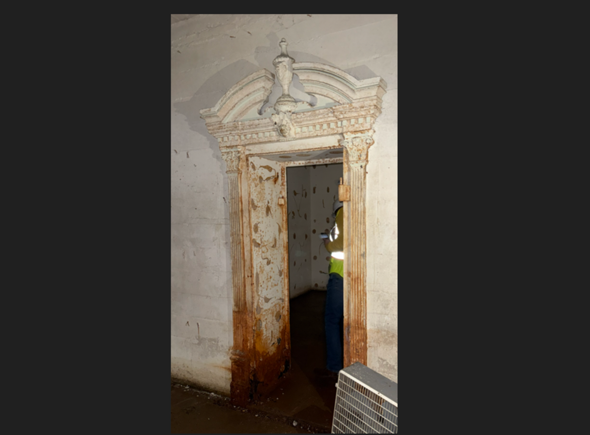 Does this look like the entrance to a vault? Rather than being industrial, the door has decorative plasterwork, classical detailing, and architectural ornamentation, officials say. Was it a disguise?