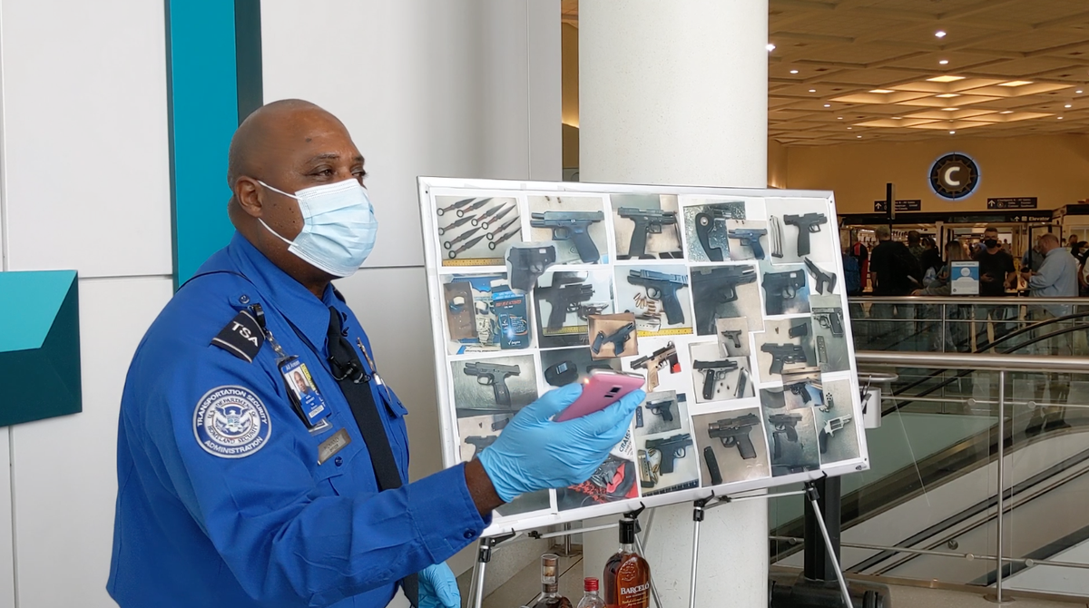 TSA officer Karl McKinney demonstrates a stun gun disguised as a phone. The item was confiscated by TSA at the Charlotte Douglas International Airport.