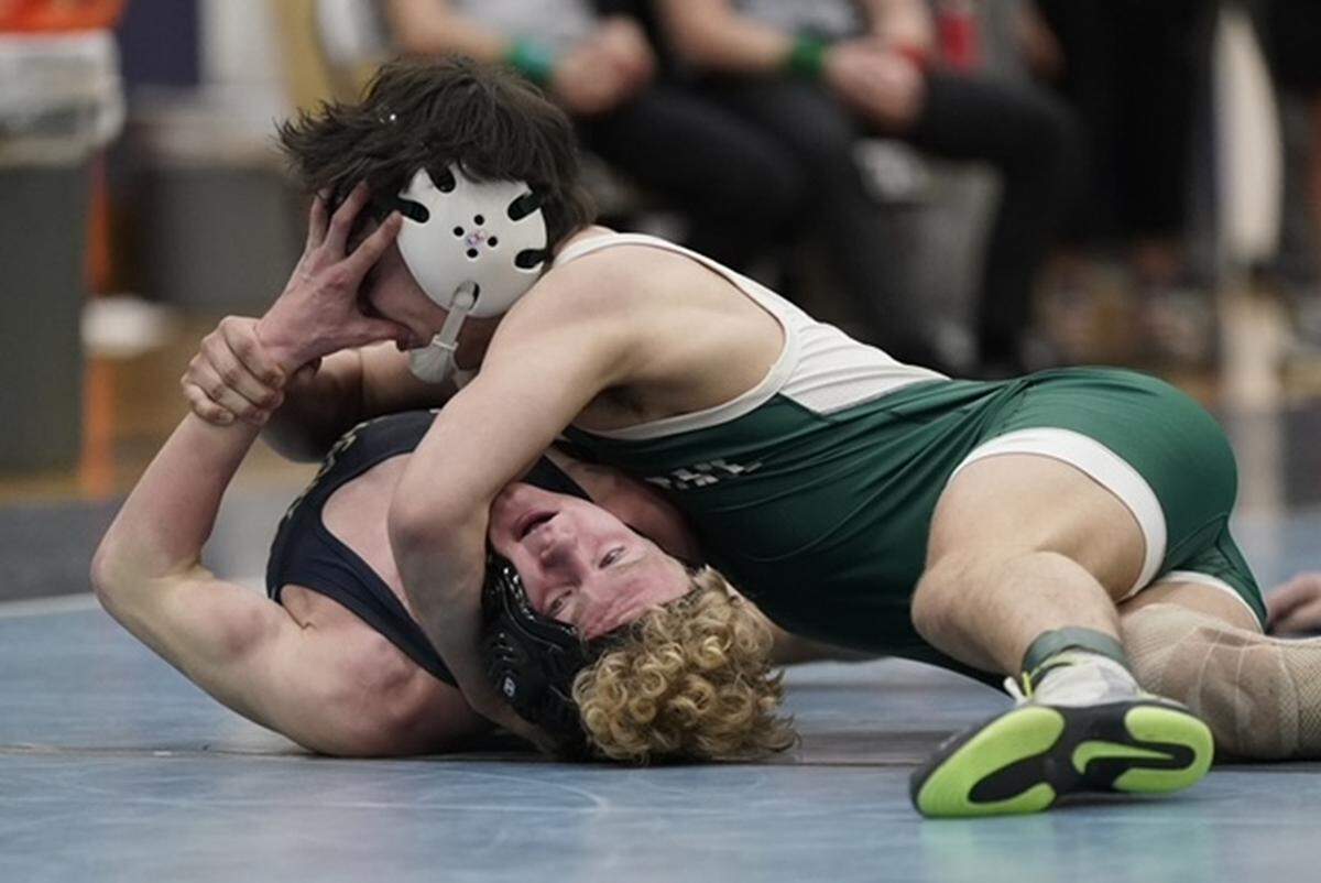 Cary Christian's Eian Holmes, bottom, tries to push Charlotte Country Day's Nicholas Arado out of his hold during their 144-pound championship match Saturday Saturday at the N.C. Independent Schools Athletic Association's state championships in Charlotte. BY BILL KISER/SPECIAL TO THE OBSERVER