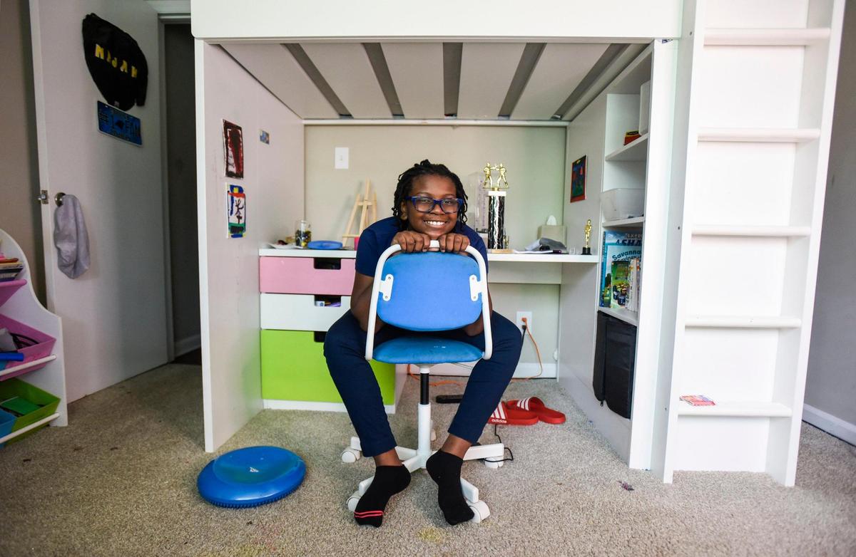 Najah Jackson poses for a portrait in her room at home on Thursday, August 19, 2021, in Charlotte. Jackson, 10, is spending her fifth grade year learning in Virtual Academy to protect her health.