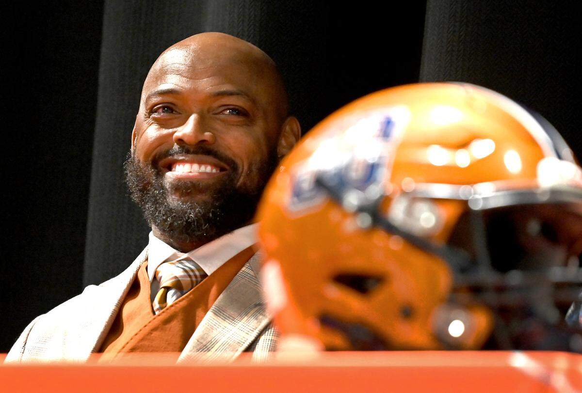 Former Carolina Panthers cornerback Captain Munnerlyn smiles as he listens to comments during his introduction as the new head football coach at Julius Chambers High School in Charlotte, NC on Friday, January 24, 2025.