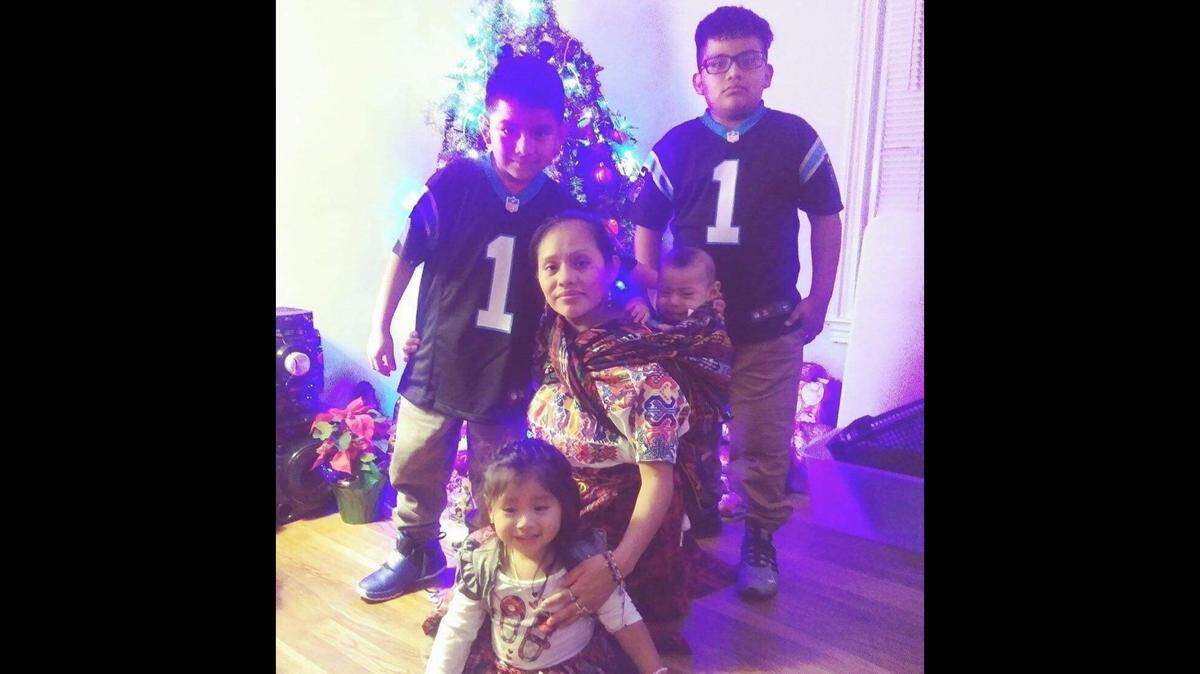 Ana Sanchez, center, posed for this photo by the family Christmas tree just two days before a house fire that took her life and the lives of Leonel (far right), and Aranza (seated in front).