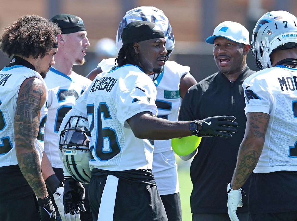 Carolina Panthers cornerback Chau Smith-Wade, center, joins his teammates in a huddle following a drill during a training camp practice on Wednesday, July 23, 2025.