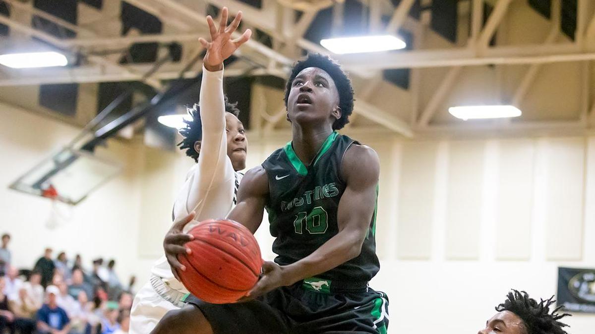 Myers Park Kameron Mack (10) drives the lane and is fouled.