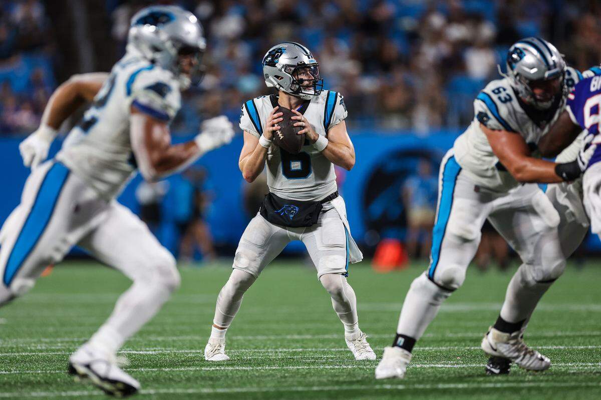 Panthers quarterback Baker Mayfield, center, looks for a pass during the game against the Bills at Bank of America Stadium on Friday, August 26, 2022 in Charlotte, NC.