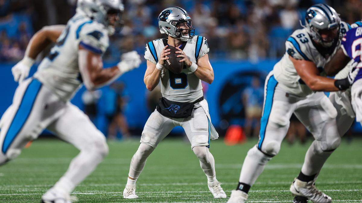 Panthers quarterback Baker Mayfield, center, looks for a pass during the game against the Bills at Bank of America Stadium on Friday, August 26, 2022 in Charlotte, NC.