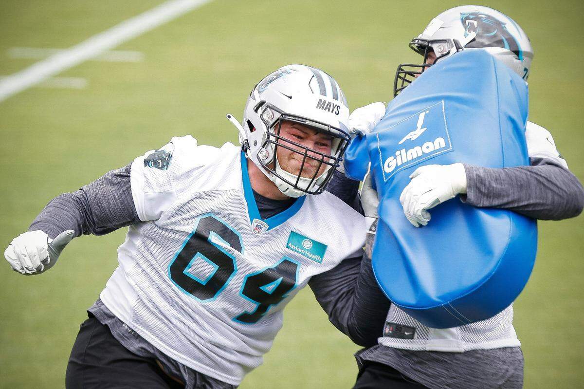 Carolina Panthers offensive lineman Cade Mays (64) runs a drill against teammate Wyatt Miller (75) during rookie minicamp at the Panthers practice field in Charlotte, N.C., Friday, May 13, 2022.