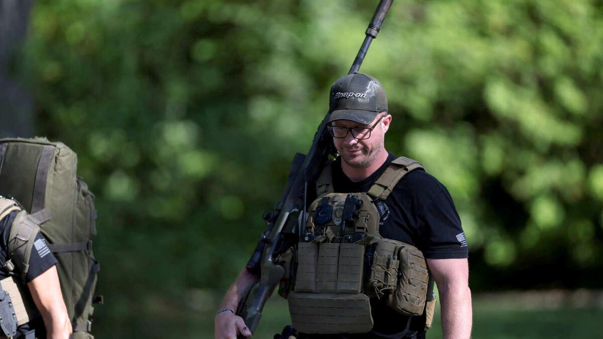 A law officer walks away from the scene at 5000 block of Galway Drive in Charlotte, NC on Monday, April 29, 2024 where multiple law enforcement officers were shot