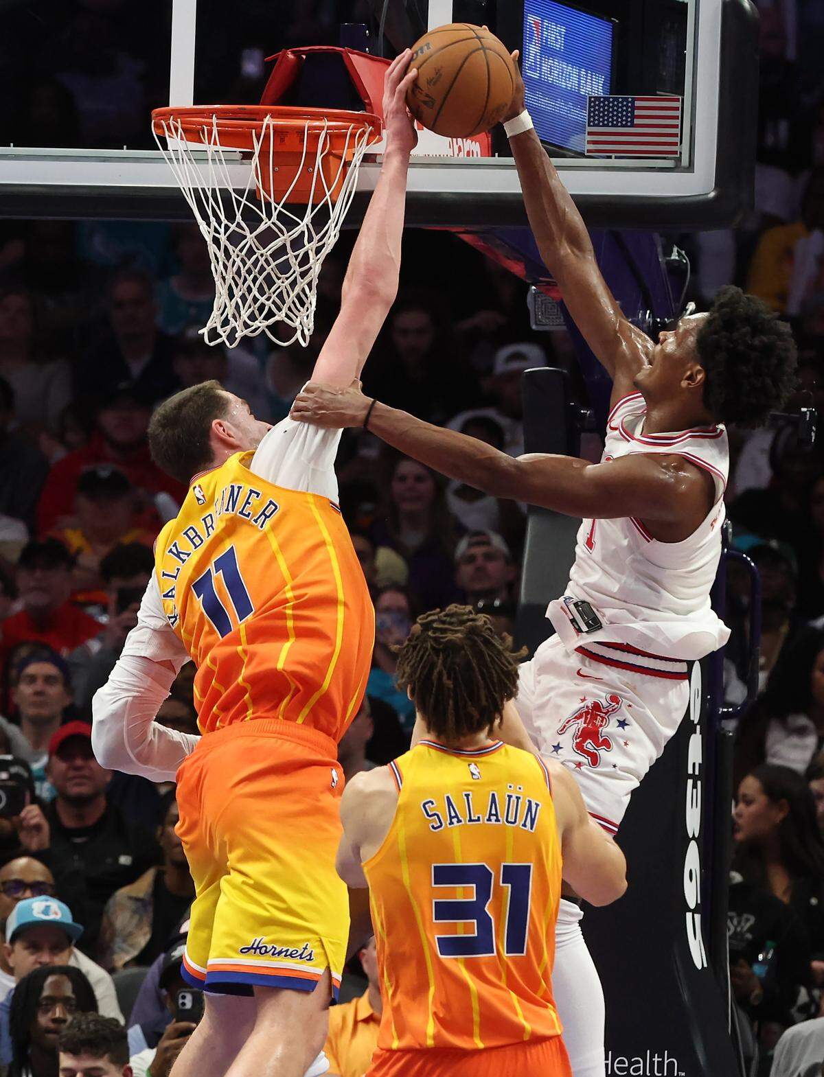 Charlotte Hornets center Ryan Kalkbrenner, left, blocks a shot by Houston Rockets guard/forward Amen Thompson, right, on a drive to the basket during action at Spectrum Center in Charlotte, NC on Thursday, February 19, 2026. 