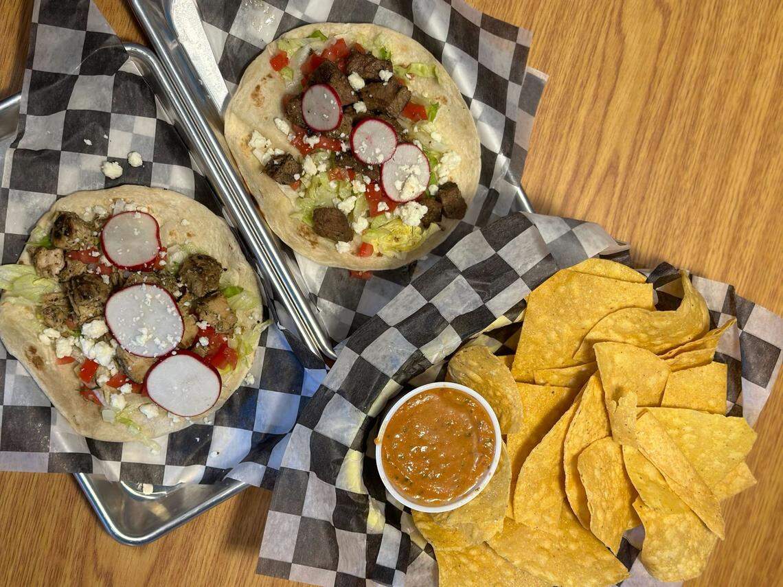 Phat Burrito’s chicken and steak tacos with chips and salsa.
