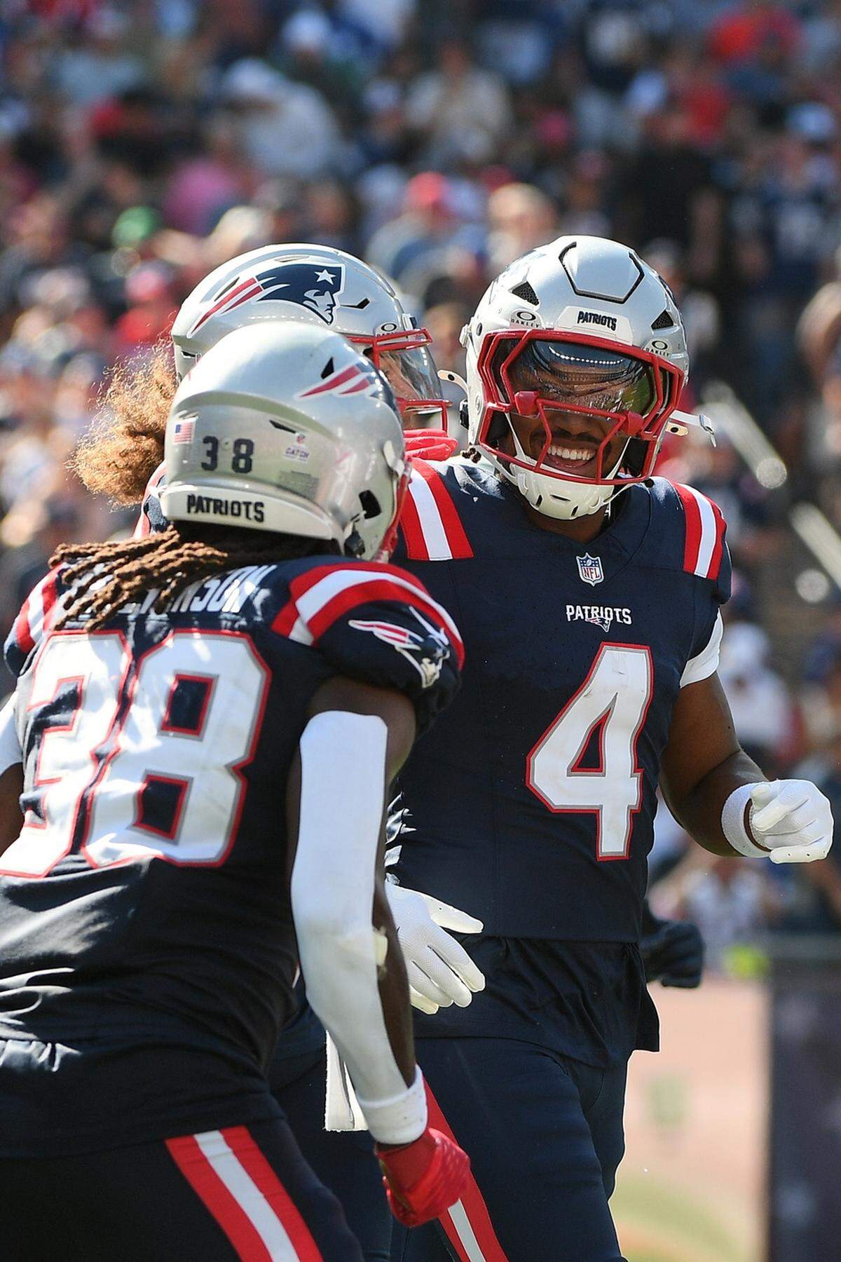 New England Patriots running back Antonio Gibson (4) smiles towards his teammates after scoring a touchdown during Sunday’s first half against the Carolina Panthers at Gillette Stadium.