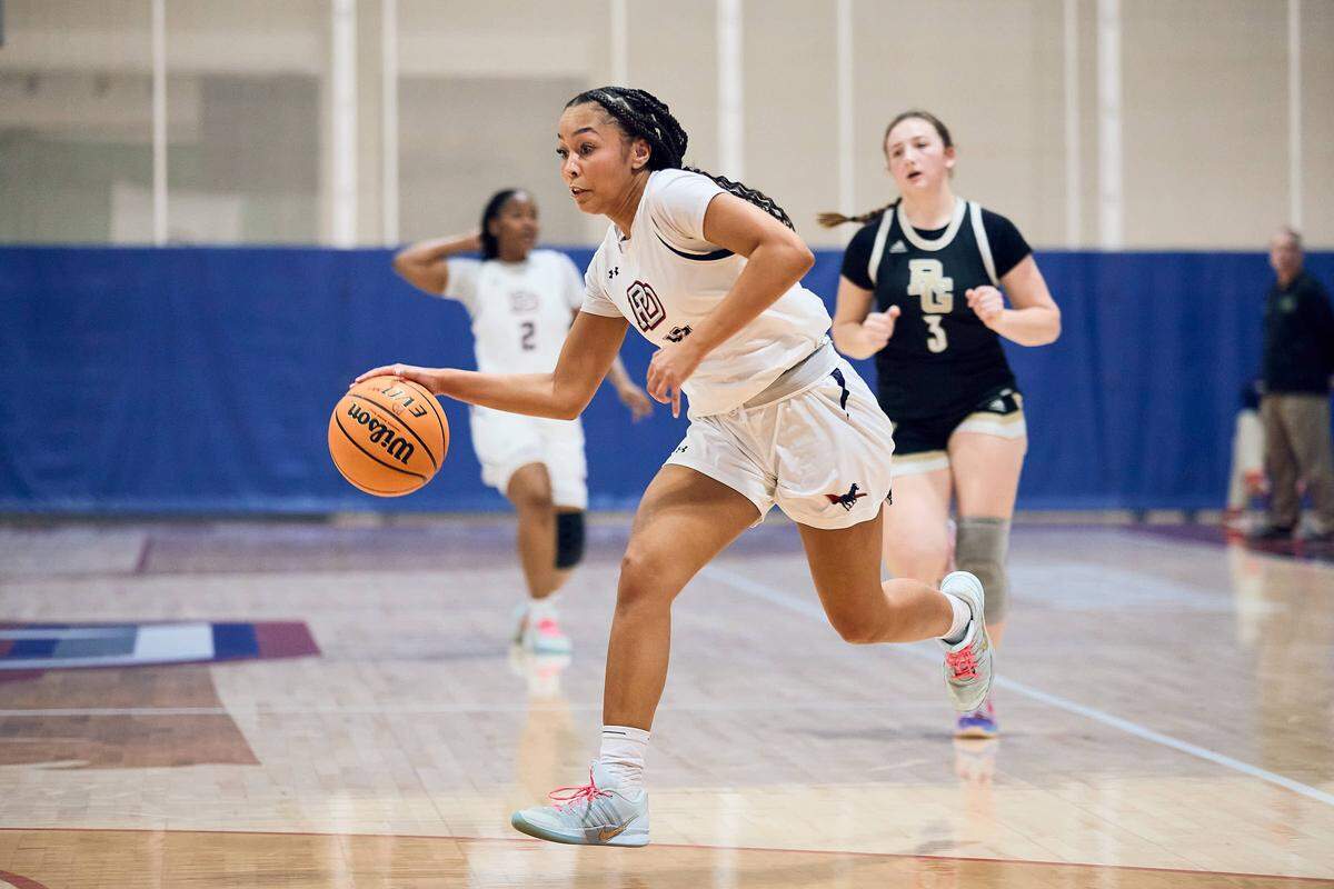 The Providence Day School Chargers guard Layla Clark (11) drives to the basket in their win over Rabun Gap in the NCISAA state semifinals on February 24, 2026.