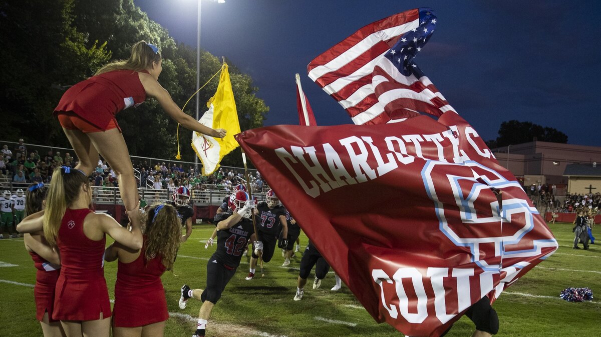 The Cougars try to break the Charlotte Catholic banner during introductions before facing Weddington at a prep football game at Charlotte Catholic High School Friday, September 28, 2018 in Charlotte, NC. Photo by JASON E. MICZEK - Special to the Observer