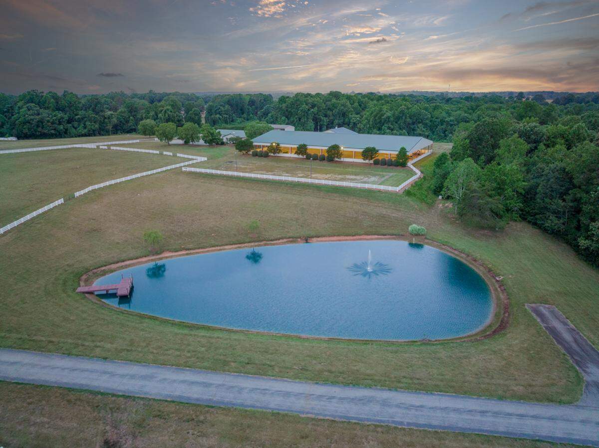 The mansion’s 140 acres include a 3-acre pond.