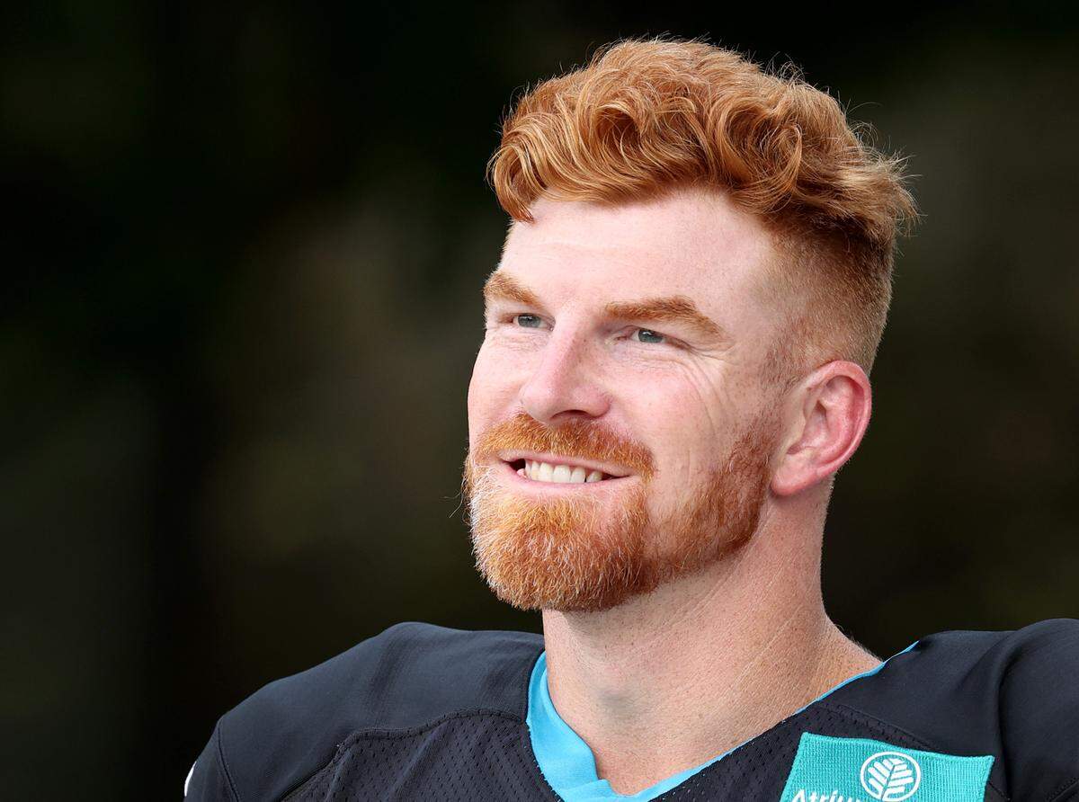 Carolina Panthers quarterback Andy Dalton smiles as he walks to practice with his teammates on Wednesday, September 25, 2024.