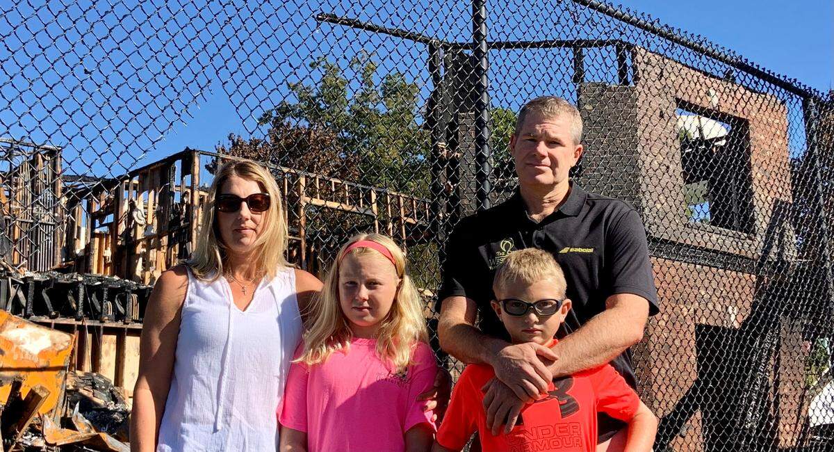 The family that owns The Club at Westport stands in front of the remains of the clubhouse, which burned down on Oct. 9, 2020. From left: Robin Dann, Sidney (age 11), Will (age 8) and Willie Dann. The Danns plan to rebuild.