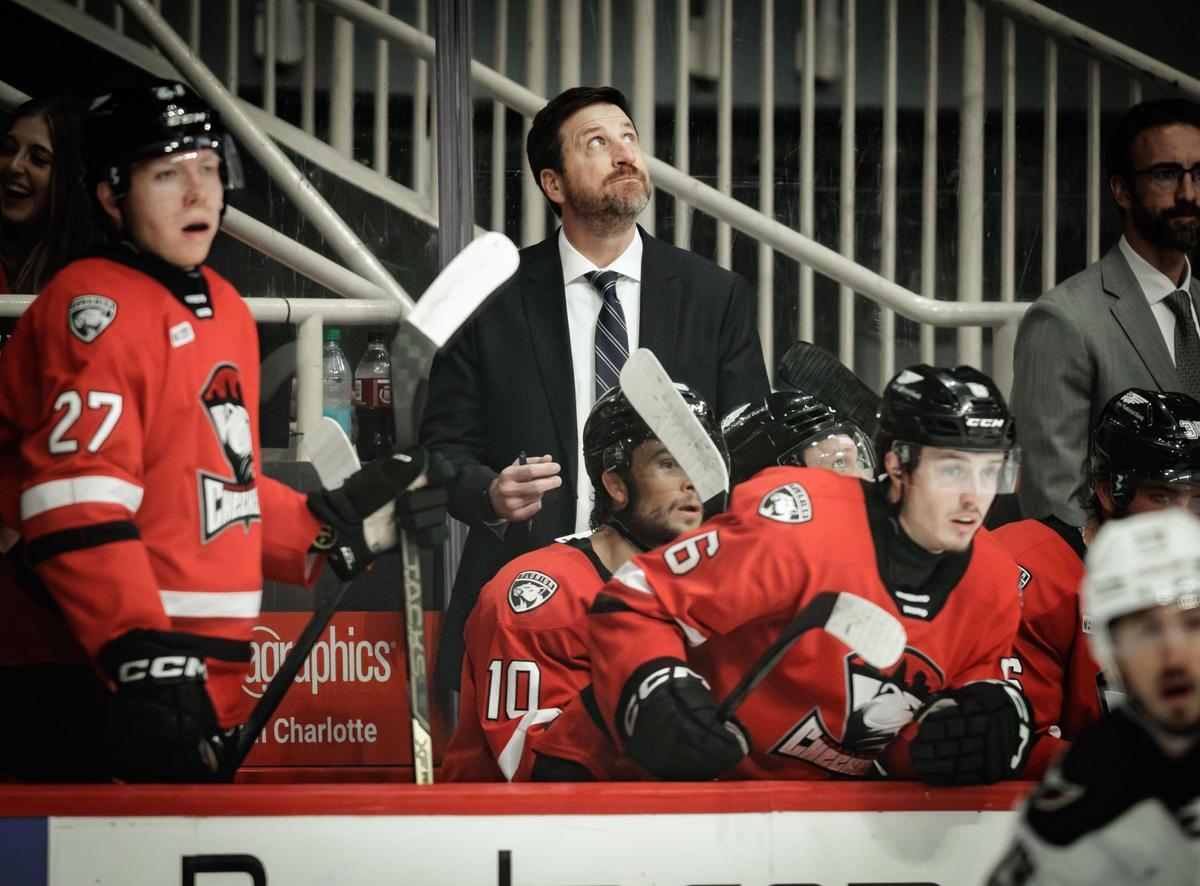 Charlotte Checkers coach Geordie Kinnear (center) looks on during his team’s playoff matchup against the Hershey Bears on Friday at Bojangles Coliseum.