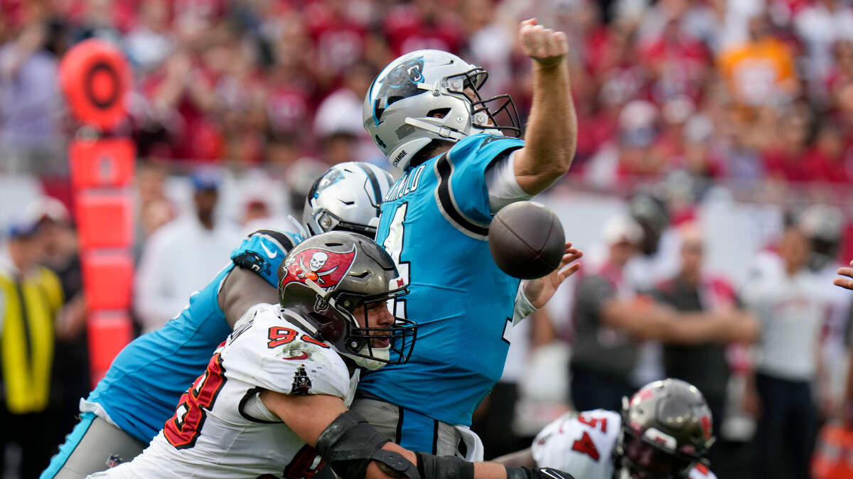 Carolina Panthers quarterback Sam Darnold is sacked by Tampa Bay Buccaneers linebacker Anthony Nelson forcing a fumble during the fourth quarter of an NFL football game between the Carolina Panthers and the Tampa Bay Buccaneers on Sunday, Jan. 1, 2023, in Tampa, Fla. The ball was recovered by Tampa Bay and was Darnold’s third turnover of the game in Carolina’s 30-24 loss to Tampa Bay.